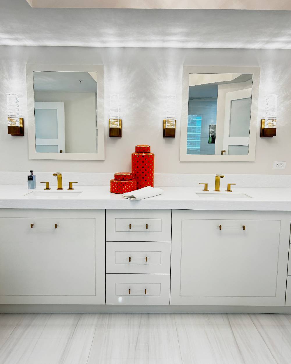 Custom-made vanity for a master bathroom with gold fixtures and acrylic handles